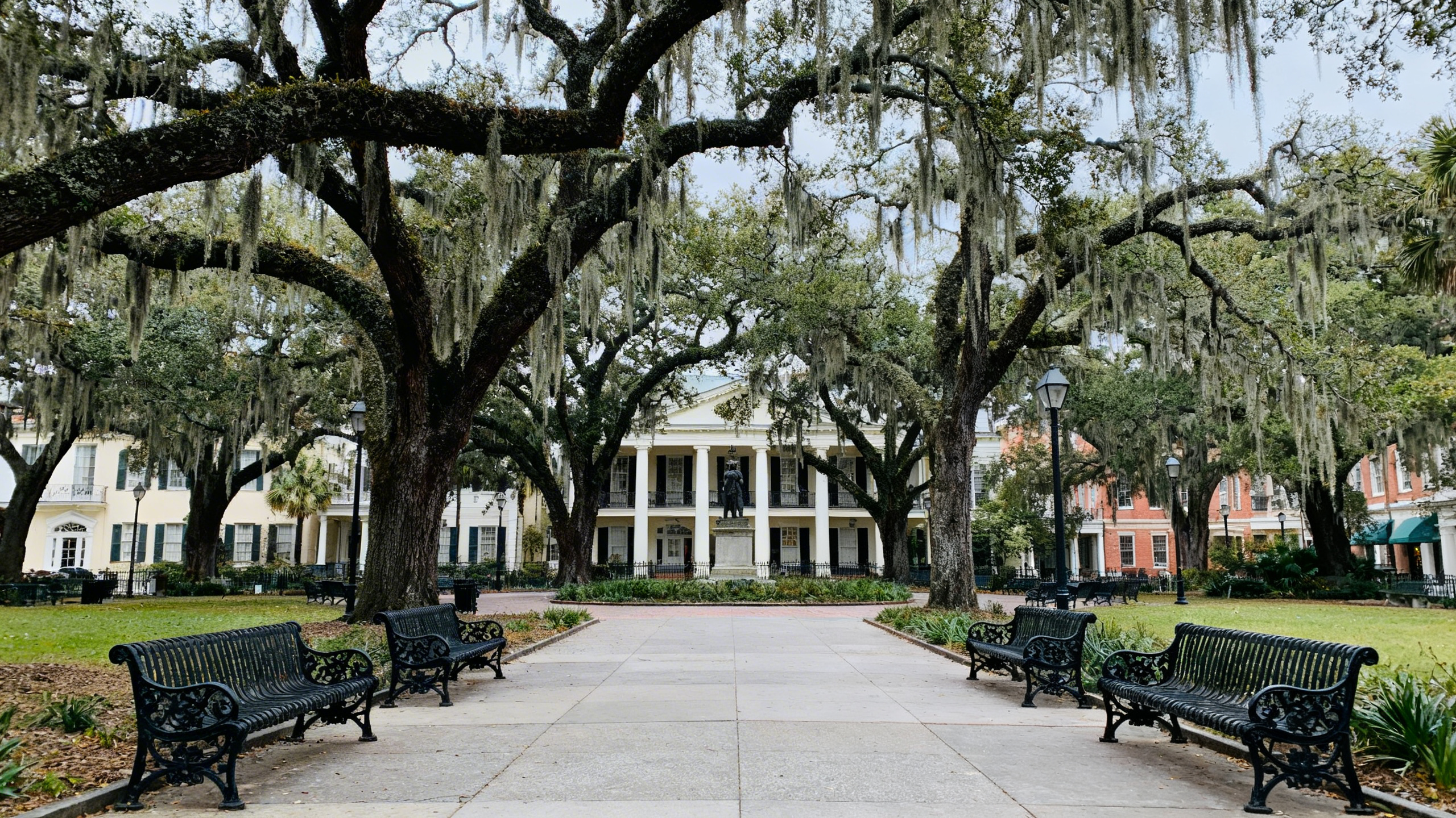 Historic squares with moss-draped oak trees and wrought-iron benches in downtown Savannah, Georgia