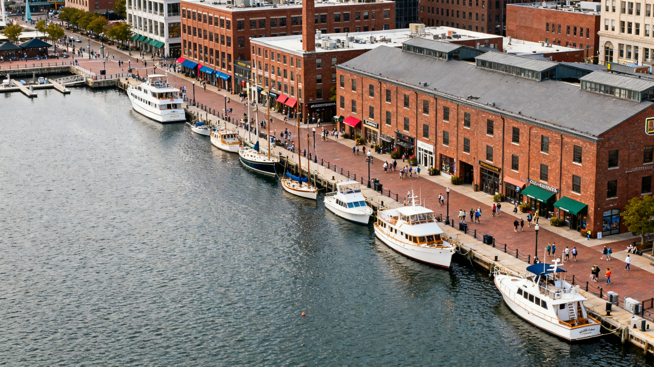 Baltimore’s Inner Harbor with boats docked along waterfront promenades and historic brick warehouses converted to shops