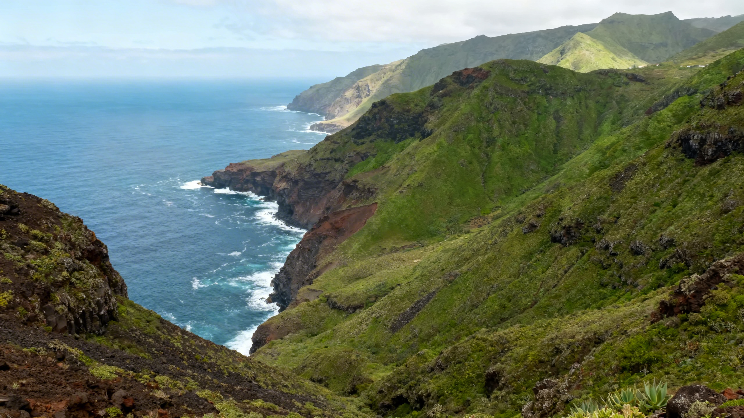Lush green volcanic hills and rugged coastline with dramatic ocean views on El Hierro, sparsely inhabited island in the Canary Islands
