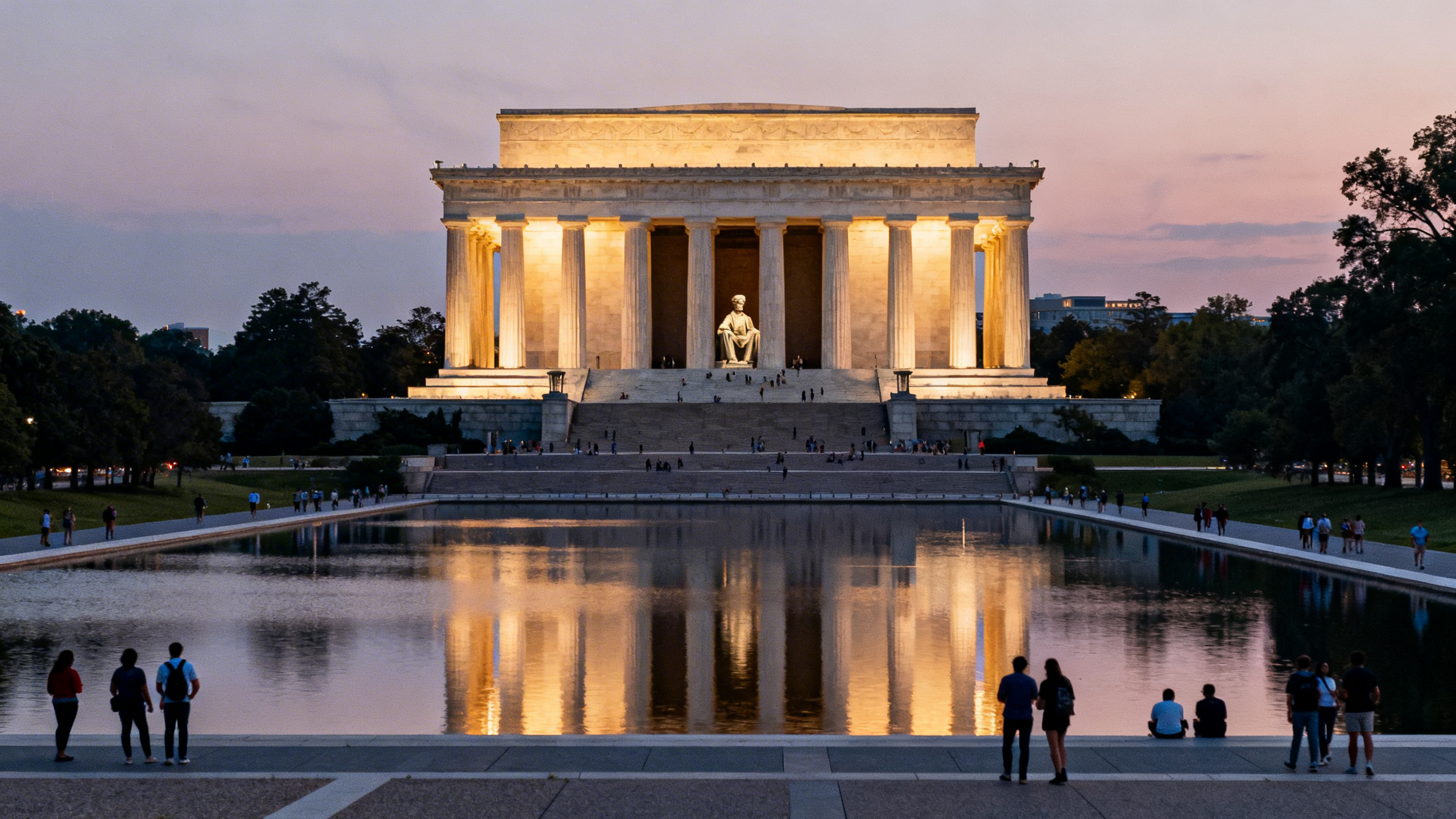 The stately Lincoln Memorial with its grand columns illuminated at dusk on the National Mall, surrounded by calm reflecting pool waters