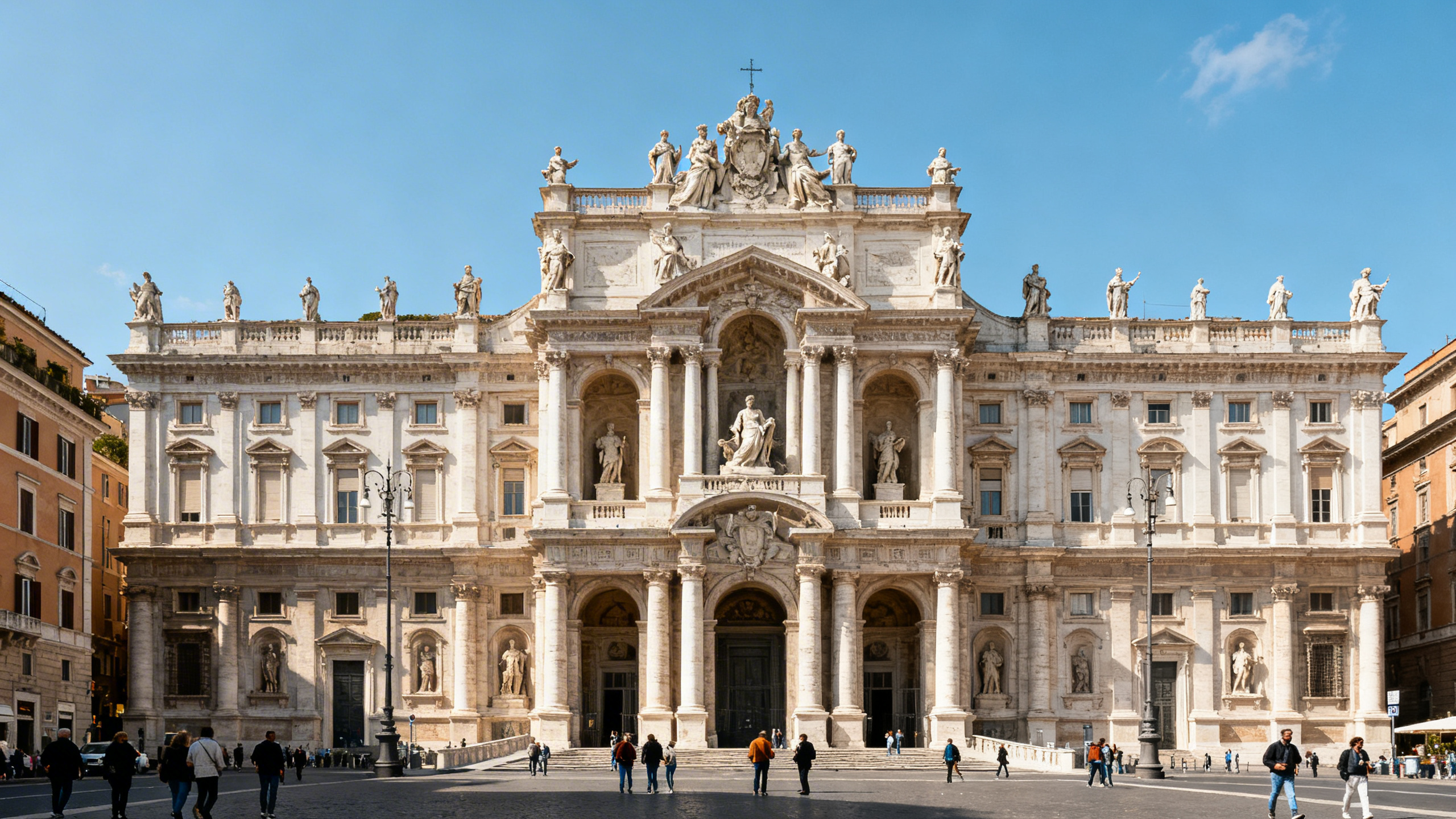 The elaborate façade of Santa Maria Maggiore Basilica decorated with sculptures and columns under bright daylight