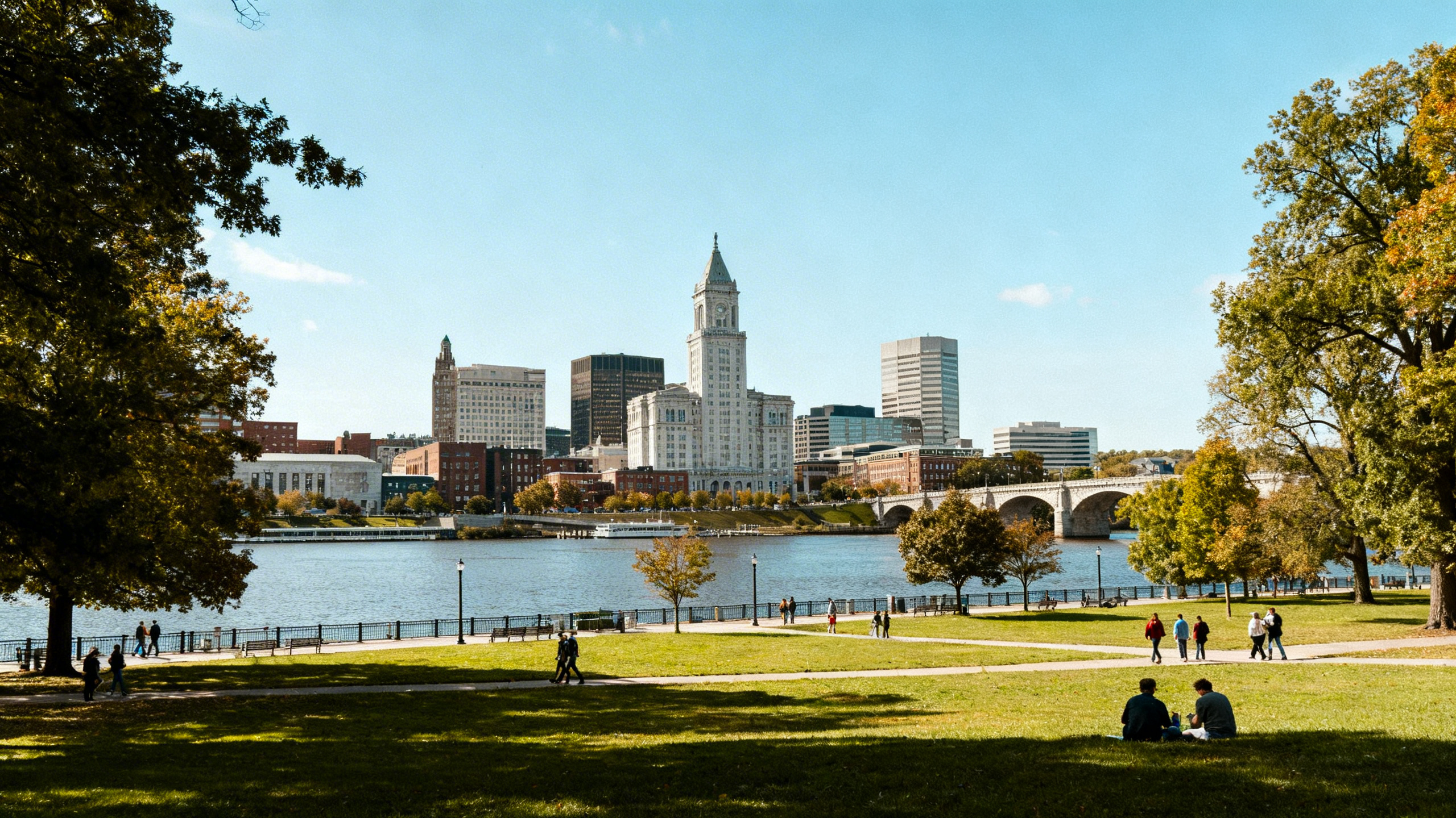 City skyline of Hartford with riverfront parks and historic architecture along the Connecticut River on a sunny day